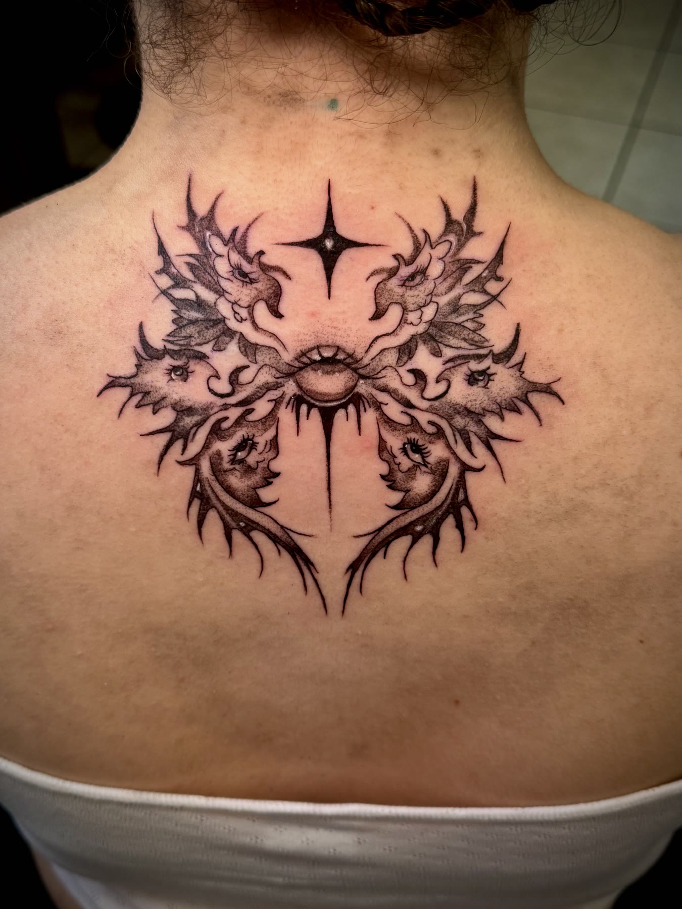 Symmetrical black and grey celestial back tattoo by Sheylla at Rockstar Tattoo